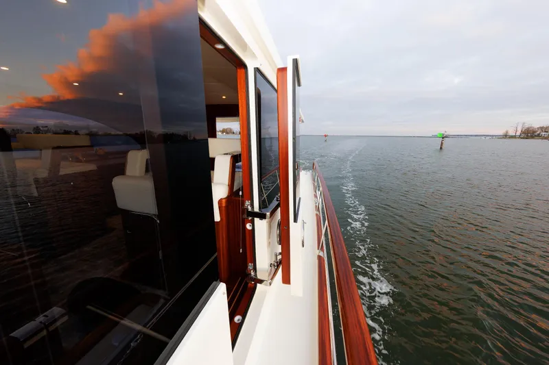 Mona Lisa Yacht Photos Pics 2025 Vicem 58 Classic yacht cruising on open water at sunset.