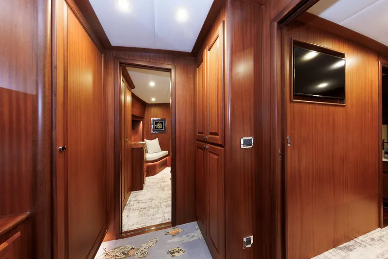 Mona Lisa Yacht Photos Pics Luxurious wood-paneled interior of 2025 Vicem 58 Classic yacht, featuring elegant hallway and seating area.