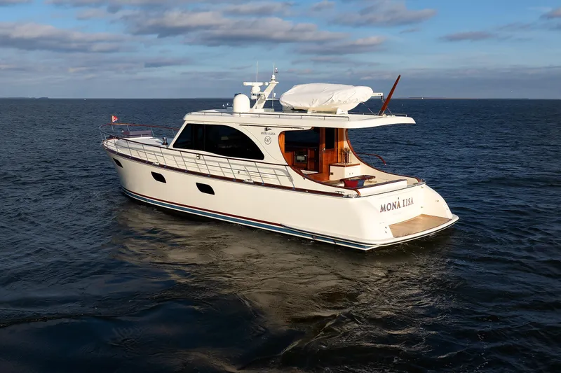 Mona Lisa Yacht Photos Pics 2025 Vicem 58 Classic yacht "Mona Lisa" cruising on open water under a cloudy sky.