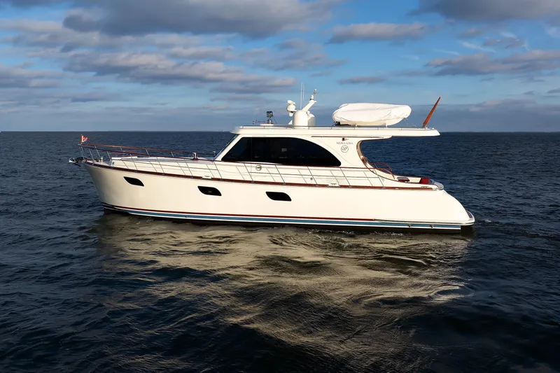 Mona Lisa Yacht Photos Pics 2025 Vicem 58 Classic yacht cruising on open water under a partly cloudy sky.