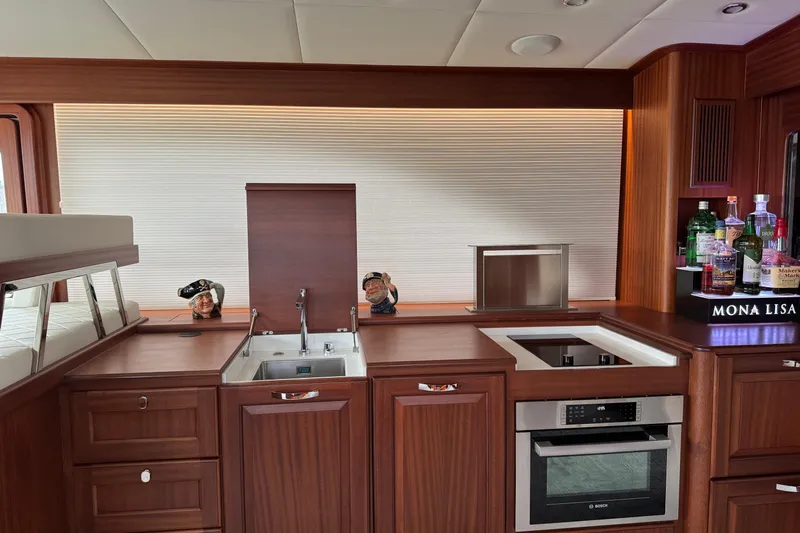 Mona Lisa Yacht Photos Pics Luxurious 2025 Vicem 58 Classic yacht interior with modern kitchen and bar setup.