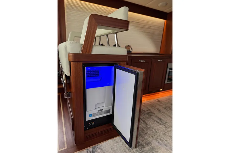 Mona Lisa Yacht Photos Pics 2025 Vicem 58 Classic yacht interior with open mini fridge, elegant wood finish.