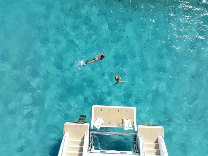 53f Iliad 2025 Yacht Photos Pics Aerial view of swimmers near ILIAD 53F yacht in clear blue water, 2026 model.