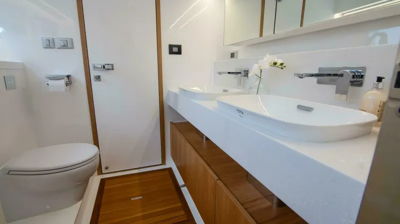 53f Iliad 2025 Yacht Photos Pics Modern bathroom in ILIAD 53F yacht, featuring dual sinks and elegant wood accents, 2026 model.