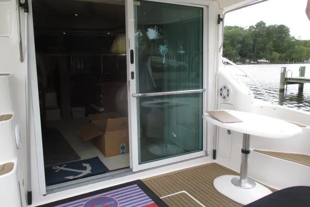 Pho-king-gross Yacht Photos Pics 2002 Sea Ray 400 Sedan Bridge yacht interior with sliding glass door and outdoor seating area.