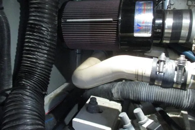 Pho-king-gross Yacht Photos Pics Engine compartment of a 2002 Sea Ray 400 Sedan Bridge with visible hoses and components.