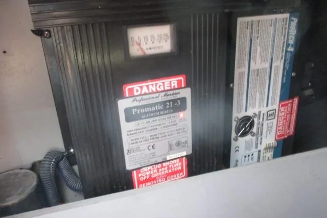 Pho-king-gross Yacht Photos Pics Electrical panel with warning labels on a 2002 Sea Ray 400 Sedan Bridge.