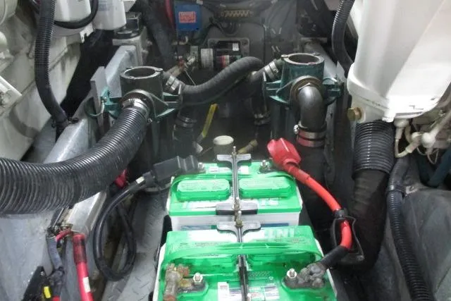 Pho-king-gross Yacht Photos Pics Engine room of a 2002 Sea Ray 400 Sedan Bridge with visible batteries and hoses.