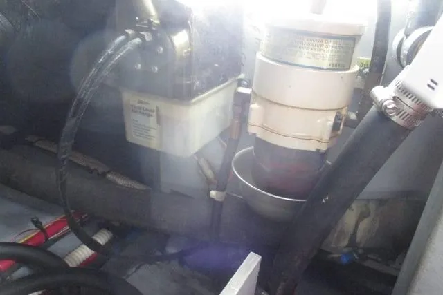 Pho-king-gross Yacht Photos Pics Engine compartment of 2002 Sea Ray 400 Sedan Bridge, showing fuel filter and hoses.