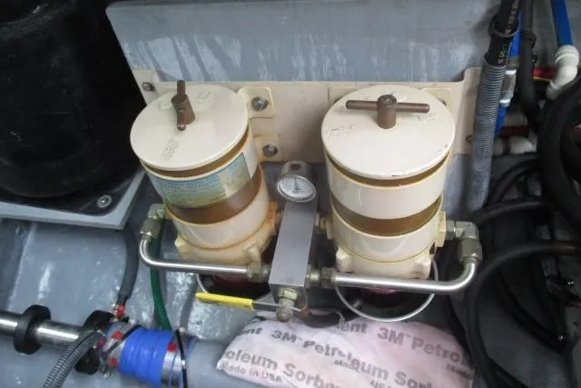 Pho-king-gross Yacht Photos Pics Engine components of a 2002 Sea Ray 400 Sedan Bridge, featuring dual filters and connected hoses.