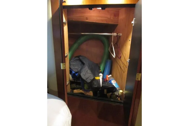 Pho-king-gross Yacht Photos Pics Storage cabinet on 2002 Sea Ray 400 Sedan Bridge with various items inside.