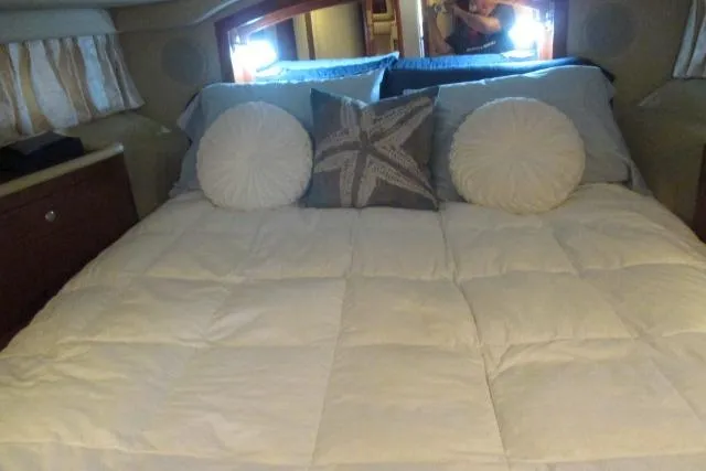 Pho-king-gross Yacht Photos Pics Cozy bedroom interior of 2002 Sea Ray 400 Sedan Bridge yacht with decorative pillows.