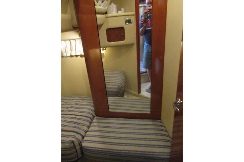 Pho-king-gross Yacht Photos Pics Interior of 2002 Sea Ray 400 Sedan Bridge with striped cushions and mirror.