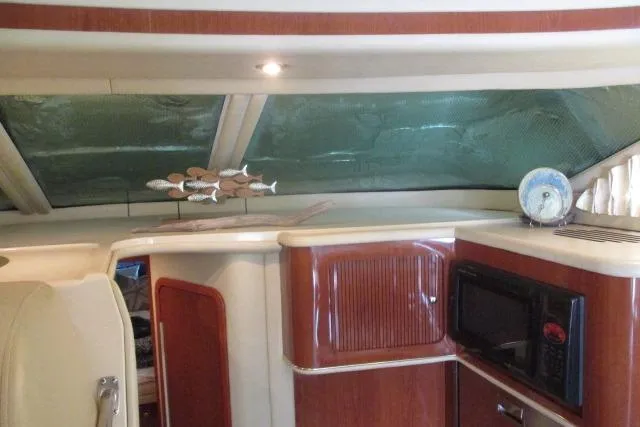 Pho-king-gross Yacht Photos Pics Interior of 2002 Sea Ray 400 Sedan Bridge with wood cabinetry and microwave.