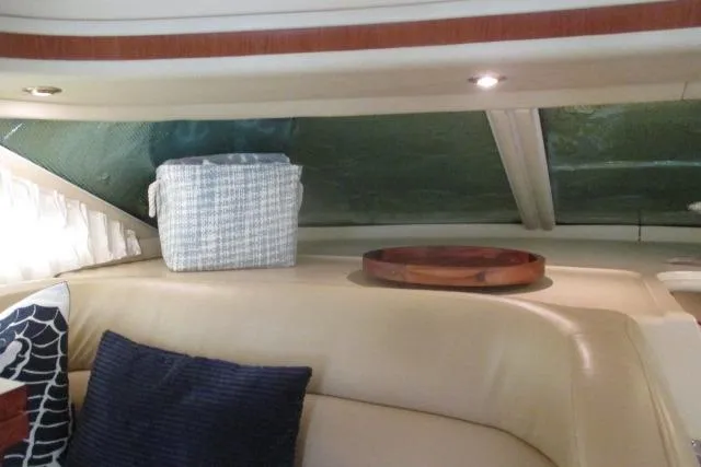 Pho-king-gross Yacht Photos Pics Interior of 2002 Sea Ray 400 Sedan Bridge with cushions and decor.