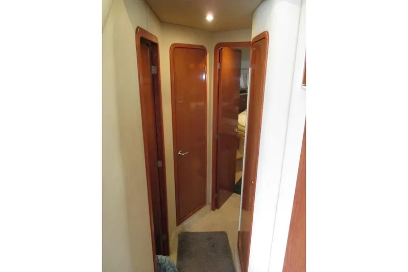 Pho-king-gross Yacht Photos Pics Interior hallway of 2002 Sea Ray 400 Sedan Bridge yacht with wooden doors.