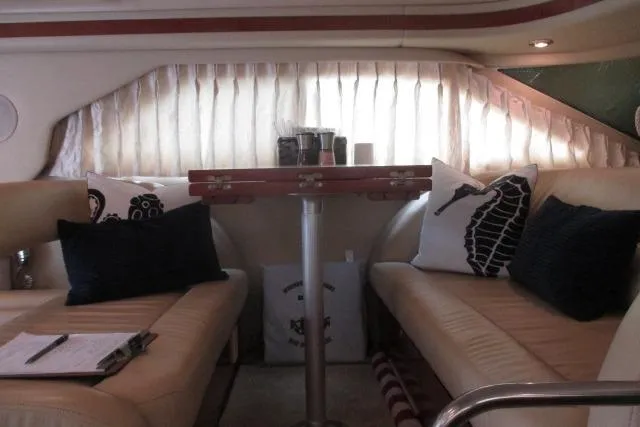 Pho-king-gross Yacht Photos Pics Interior of 2002 Sea Ray 400 Sedan Bridge with beige seating and decorative pillows.