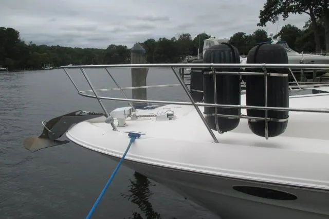 Pho-king-gross Yacht Photos Pics 2002 Sea Ray 400 Sedan Bridge yacht docked, featuring bow railings and fenders on a calm waterway.