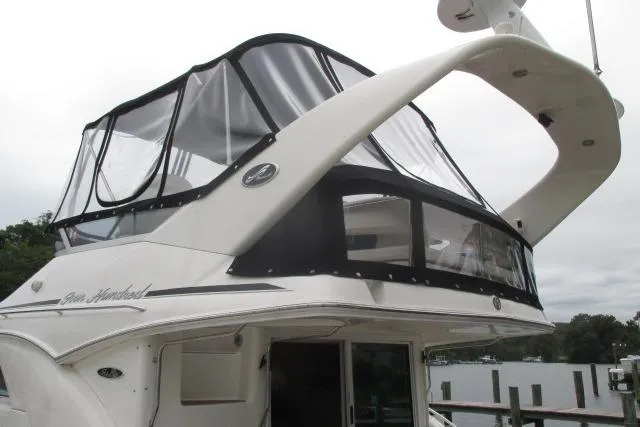 Pho-king-gross Yacht Photos Pics 2002 Sea Ray 400 Sedan Bridge yacht with enclosed flybridge, docked at a marina.