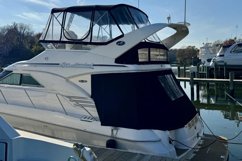 Pho-king-gross Yacht Photos Pics 2002 Sea Ray 400 Sedan Bridge yacht docked at marina, featuring sleek design and covered upper deck.