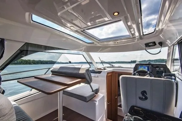  Yacht Photos Pics Interior of 2024 Beneteau Antares 9 boat with panoramic windows and modern seating.