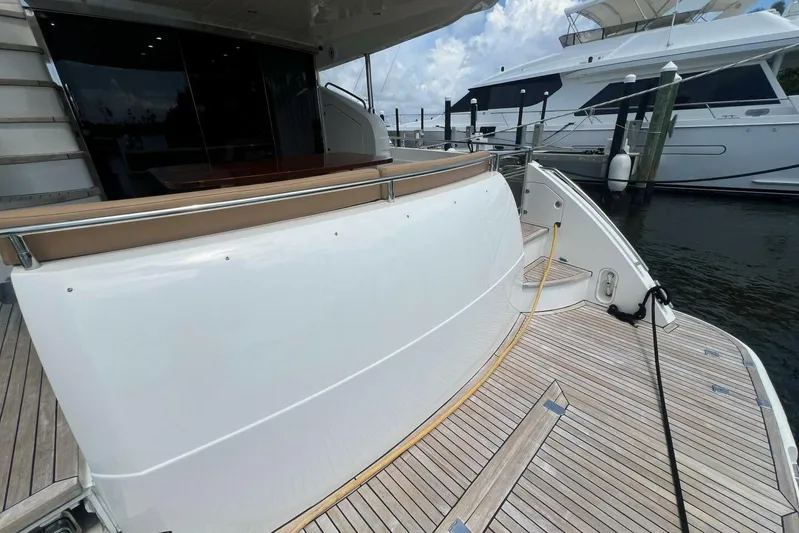  Yacht Photos Pics 2006 Princess 67 Flybridge yacht docked, showcasing sleek design and spacious deck area.