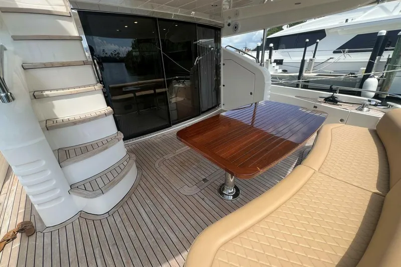  Yacht Photos Pics Luxurious 2006 Princess 67 Flybridge yacht with elegant deck seating and wooden table.