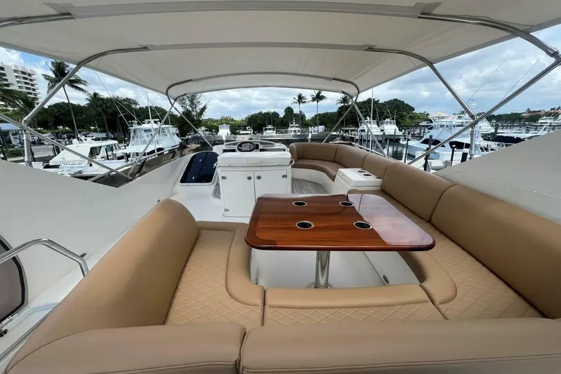  Yacht Photos Pics Luxurious 2006 Princess 67 Flybridge yacht with spacious seating and elegant wood table.