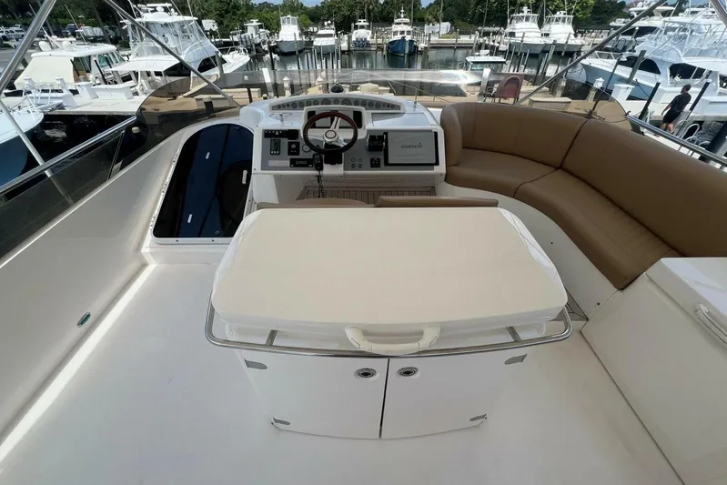  Yacht Photos Pics Luxurious 2006 Princess 67 Flybridge yacht interior with helm and seating area.