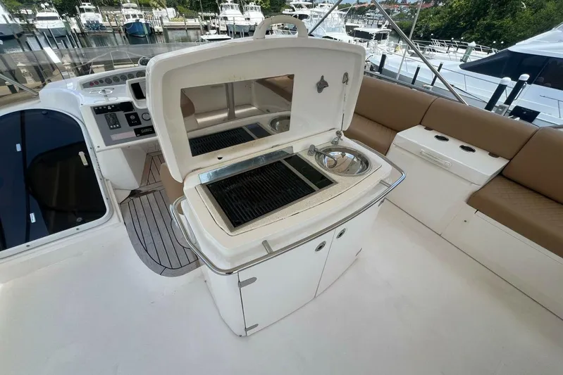  Yacht Photos Pics Flybridge of 2006 Princess 67 yacht with grill and seating area.