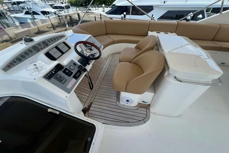  Yacht Photos Pics Flybridge of 2006 Princess 67 yacht with helm, seating, and controls.