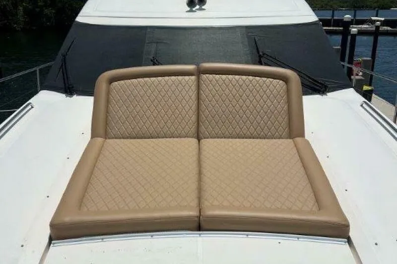  Yacht Photos Pics Luxurious seating on 2006 Princess 67 Flybridge yacht, featuring quilted tan cushions.