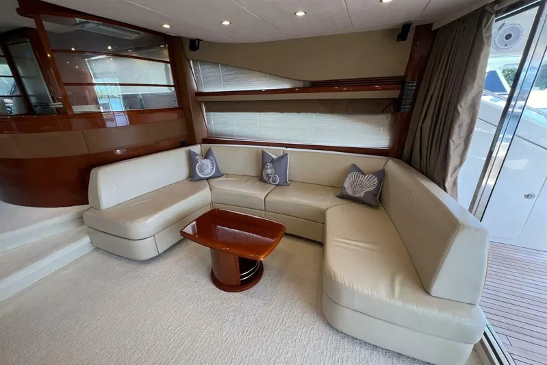  Yacht Photos Pics Luxurious interior of 2006 Princess 67 Flybridge yacht with elegant seating and wooden accents.