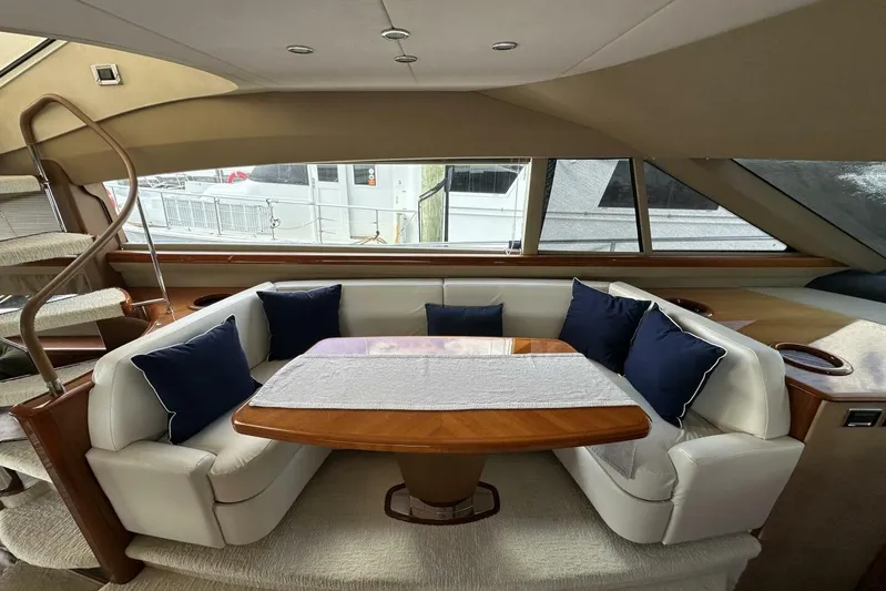  Yacht Photos Pics Luxurious 2006 Princess 67 Flybridge yacht interior with elegant seating and wooden table.