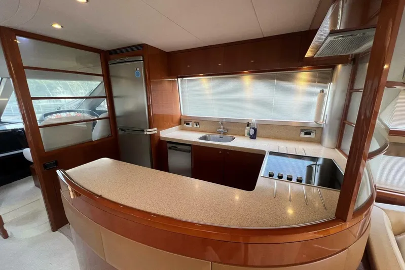  Yacht Photos Pics Luxurious kitchen interior of 2006 Princess 67 Flybridge yacht with modern amenities.