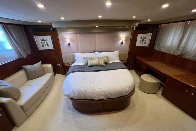  Yacht Photos Pics Luxurious bedroom interior of 2006 Princess 67 Flybridge yacht with elegant decor and cozy seating.