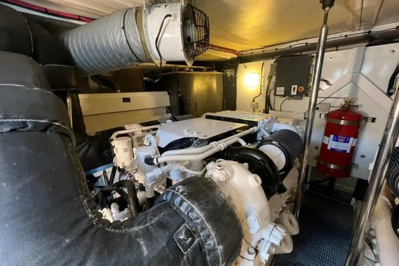  Yacht Photos Pics Engine room of 2006 Princess 67 Flybridge yacht, featuring machinery and fire extinguisher.