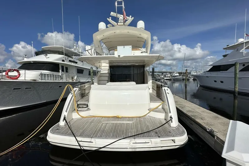  Yacht Photos Pics 2006 Princess 67 Flybridge yacht docked at marina under clear blue sky.