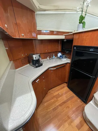 Zoto Yacht Photos Pics Luxurious 2003 Sea Ray 390 Motor Yacht kitchen with wood cabinetry and modern appliances.