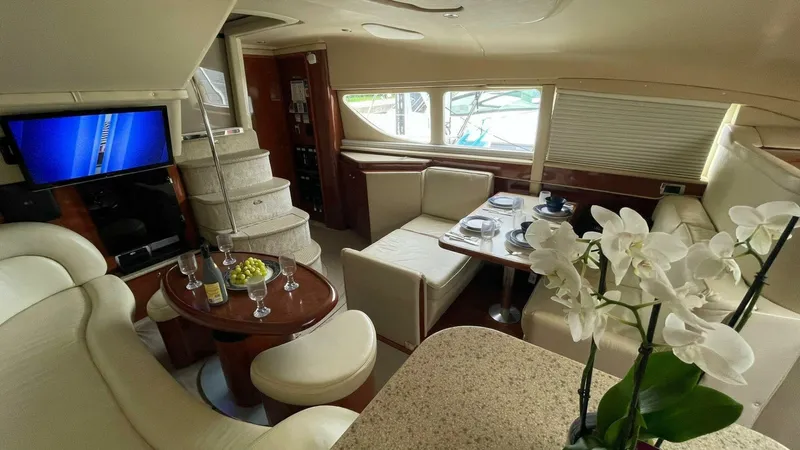 Zoto Yacht Photos Pics Luxurious interior of 2003 Sea Ray 390 Motor Yacht with elegant seating and dining area.