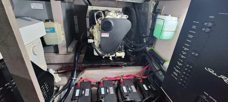Zoto Yacht Photos Pics Engine room of a 2003 Sea Ray 390 Motor Yacht with visible batteries and control panel.