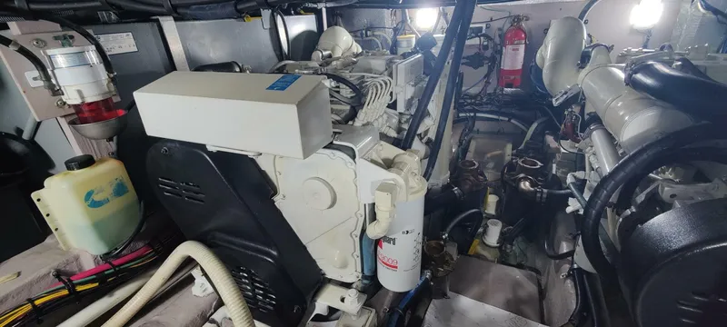 Zoto Yacht Photos Pics Engine room of a 2003 Sea Ray 390 Motor Yacht, showcasing mechanical components and wiring.