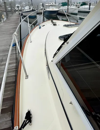 Linda Lou Yacht Photos Pics 2018 Legacy 36 boat docked, showcasing sleek deck design and railing.