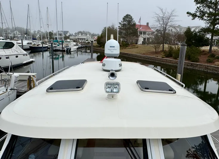Linda Lou Yacht Photos Pics 2018 Legacy 36 yacht docked at marina, featuring radar and navigation equipment.