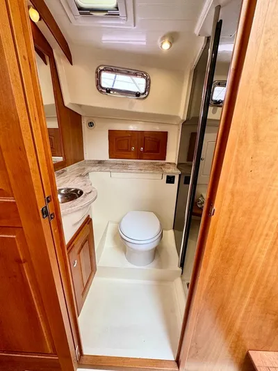 Linda Lou Yacht Photos Pics 2018 Legacy 36 yacht bathroom with wooden cabinetry and modern fixtures.
