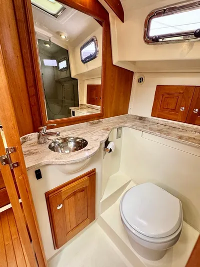 Linda Lou Yacht Photos Pics 2018 Legacy 36 yacht bathroom with wooden cabinetry and modern fixtures.