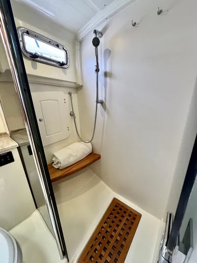 Linda Lou Yacht Photos Pics 2018 Legacy 36 yacht bathroom with shower, wooden bench, and window.
