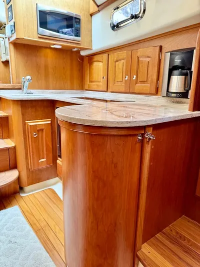 Linda Lou Yacht Photos Pics 2018 Legacy 36 yacht kitchen with wood cabinetry, microwave, and coffee maker.