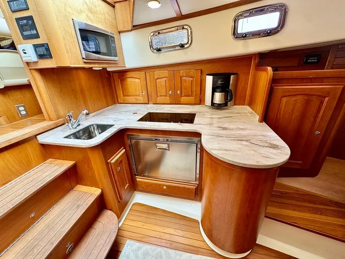 Linda Lou Yacht Photos Pics Luxurious 2018 Legacy 36 yacht kitchen with wood cabinetry and modern appliances.