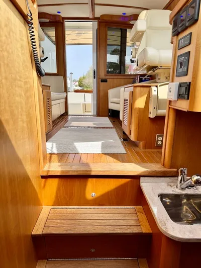 Linda Lou Yacht Photos Pics Interior of 2018 Legacy 36 boat, featuring wooden flooring and modern amenities.